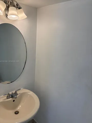 a bathroom with a sink and mirror