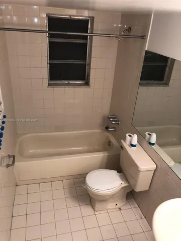 a bathroom with a toilet a sink and bathtub
