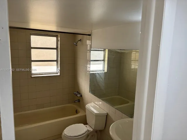 a bathroom with a toilet and a bathtub