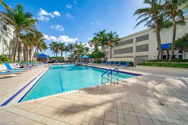 a park with lots of palm trees and slides