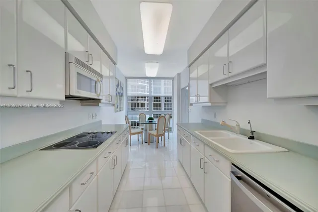 a kitchen with stainless steel appliances a sink a stove and cabinets