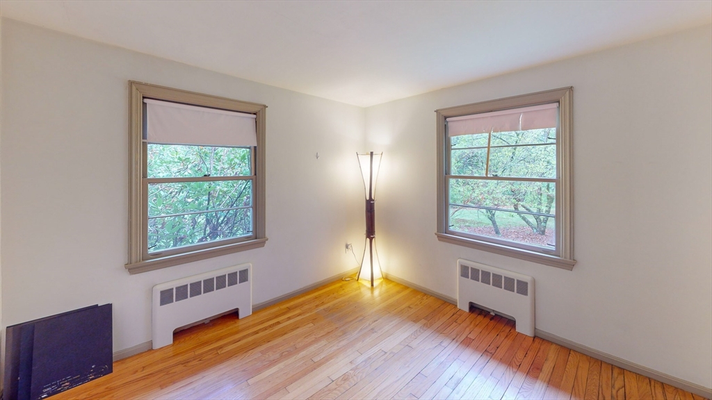 116 Lincoln Road Wayland, MA 01778 - Photo 13 of 26 an empty room with wooden floor and windows