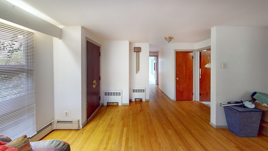 116 Lincoln Road Wayland, MA 01778 - Photo 17 of 26 a bedroom with a bed and wooden floor