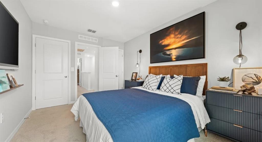 2924 Skyline Loop Kissimmee, FL 34758 - Photo 11 of 22 a bedroom with a bed and a flat screen tv