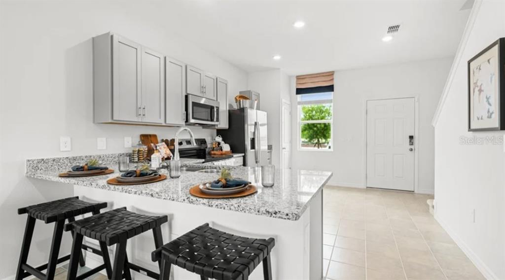 2924 Skyline Loop Kissimmee, FL 34758 - Photo 6 of 22 a view of a dining room with furniture and a window