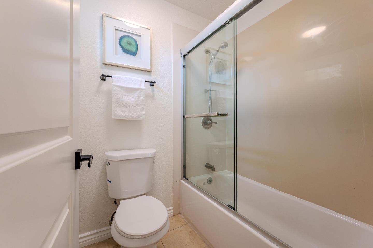 99 Jacklin Court Milpitas, CA 95035 - Photo 16 of 25 a white toilet sitting next to a bath tub