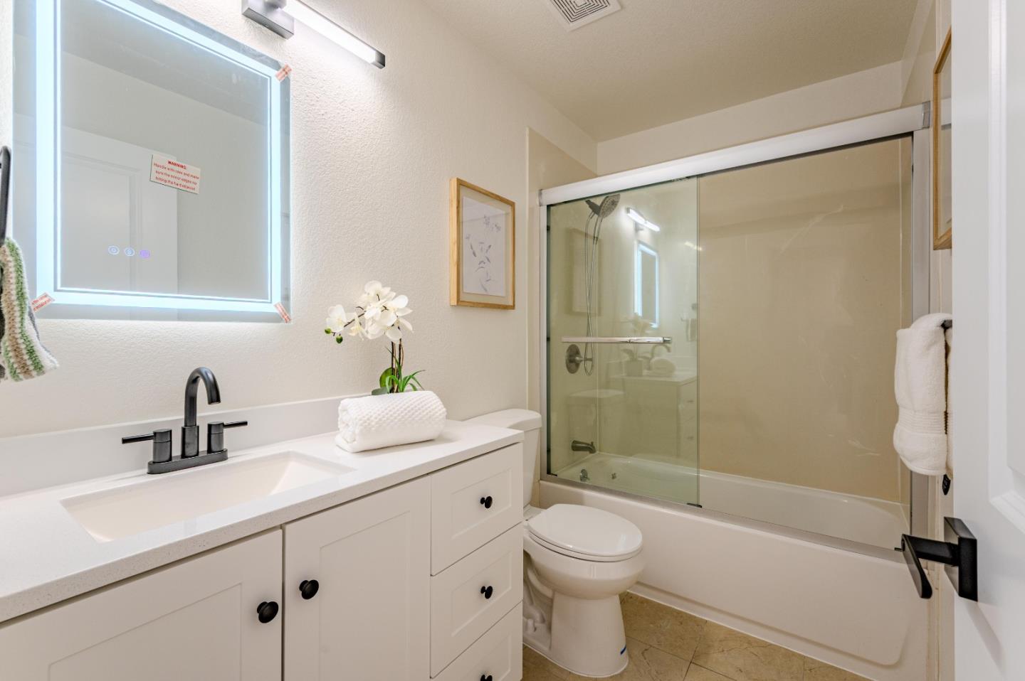 99 Jacklin Court Milpitas, CA 95035 - Photo 20 of 25 a bathroom with a sink a toilet and shower