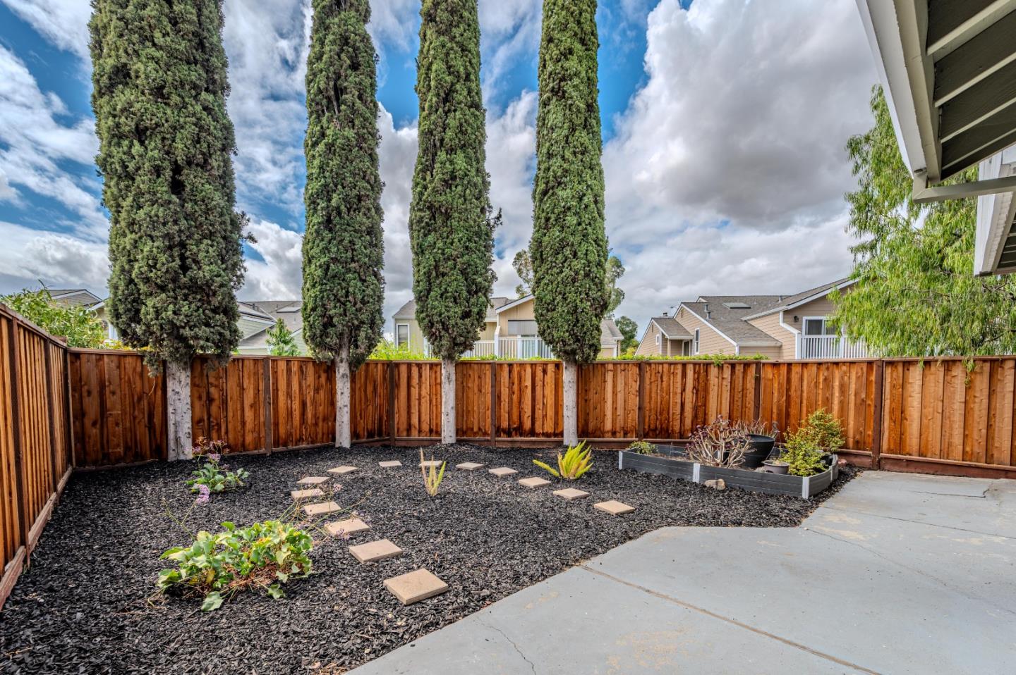99 Jacklin Court Milpitas, CA 95035 - Photo 23 of 25 a view of backyard with potted plants and wooden fence