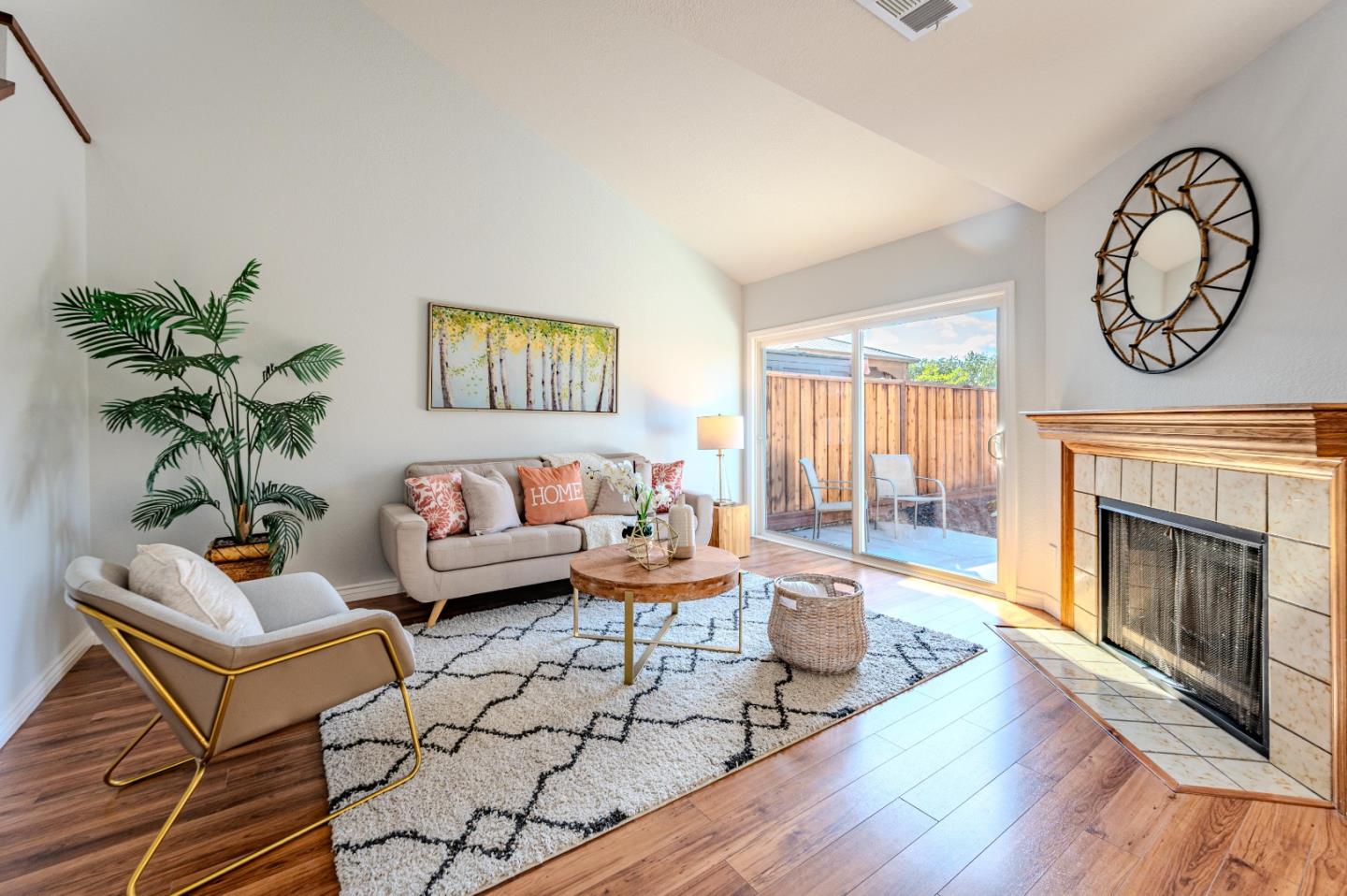 99 Jacklin Court Milpitas, CA 95035 - Photo 4 of 25 a living room with furniture a fireplace and wall paintings
