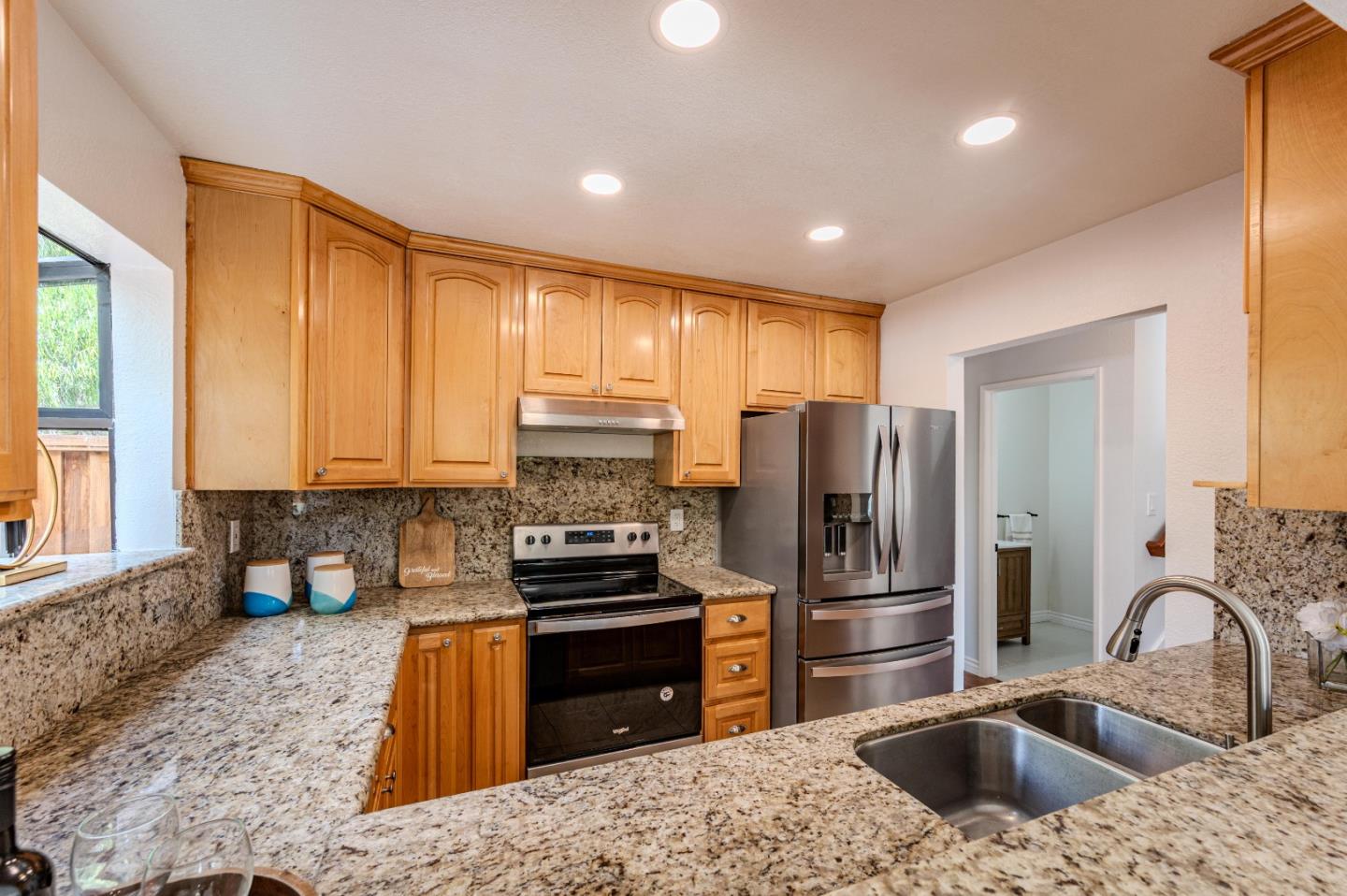 99 Jacklin Court Milpitas, CA 95035 - Photo 8 of 25 a kitchen with granite countertop a refrigerator and a sink