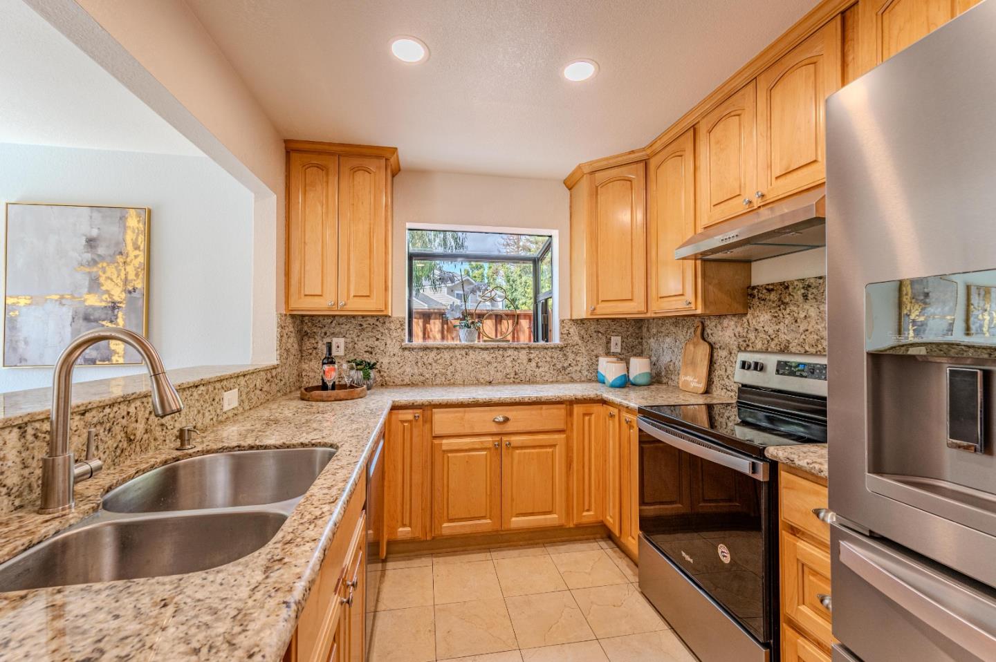 99 Jacklin Court Milpitas, CA 95035 - Photo 10 of 25 a kitchen with stainless steel appliances granite countertop a sink a stove cabinets counter space and a window