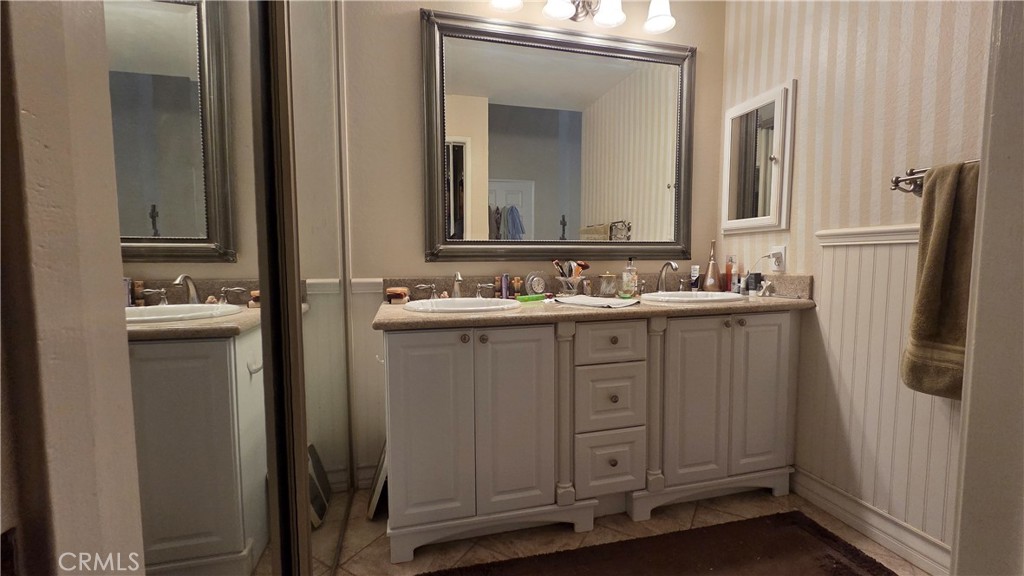 4 Leesburg Irvine, CA 92620 - Photo 14 of 18 a bathroom with a sink vanity and a mirror