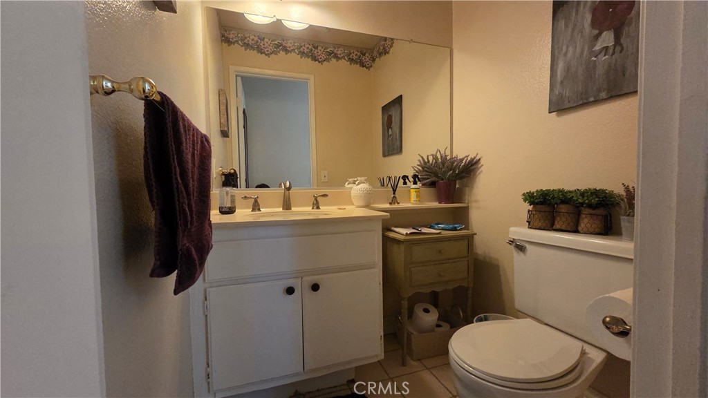 4 Leesburg Irvine, CA 92620 - Photo 18 of 18 a bathroom with a sink a toilet a mirror and shower curtain
