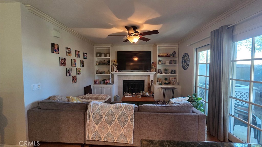 4 Leesburg Irvine, CA 92620 - Photo 10 of 18 a living room with furniture a fireplace and a flat screen tv