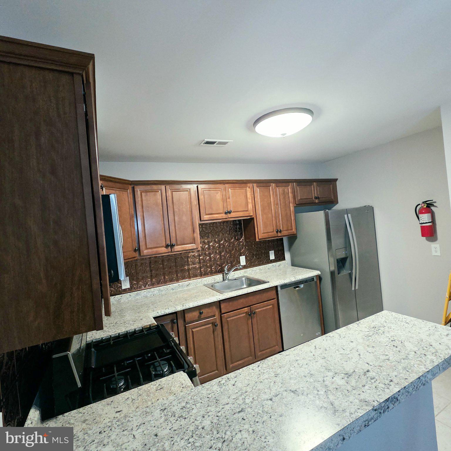 208 Ashley Run Voorhees, NJ 08043 - Photo 11 of 23 a kitchen with a sink a stove and refrigerator