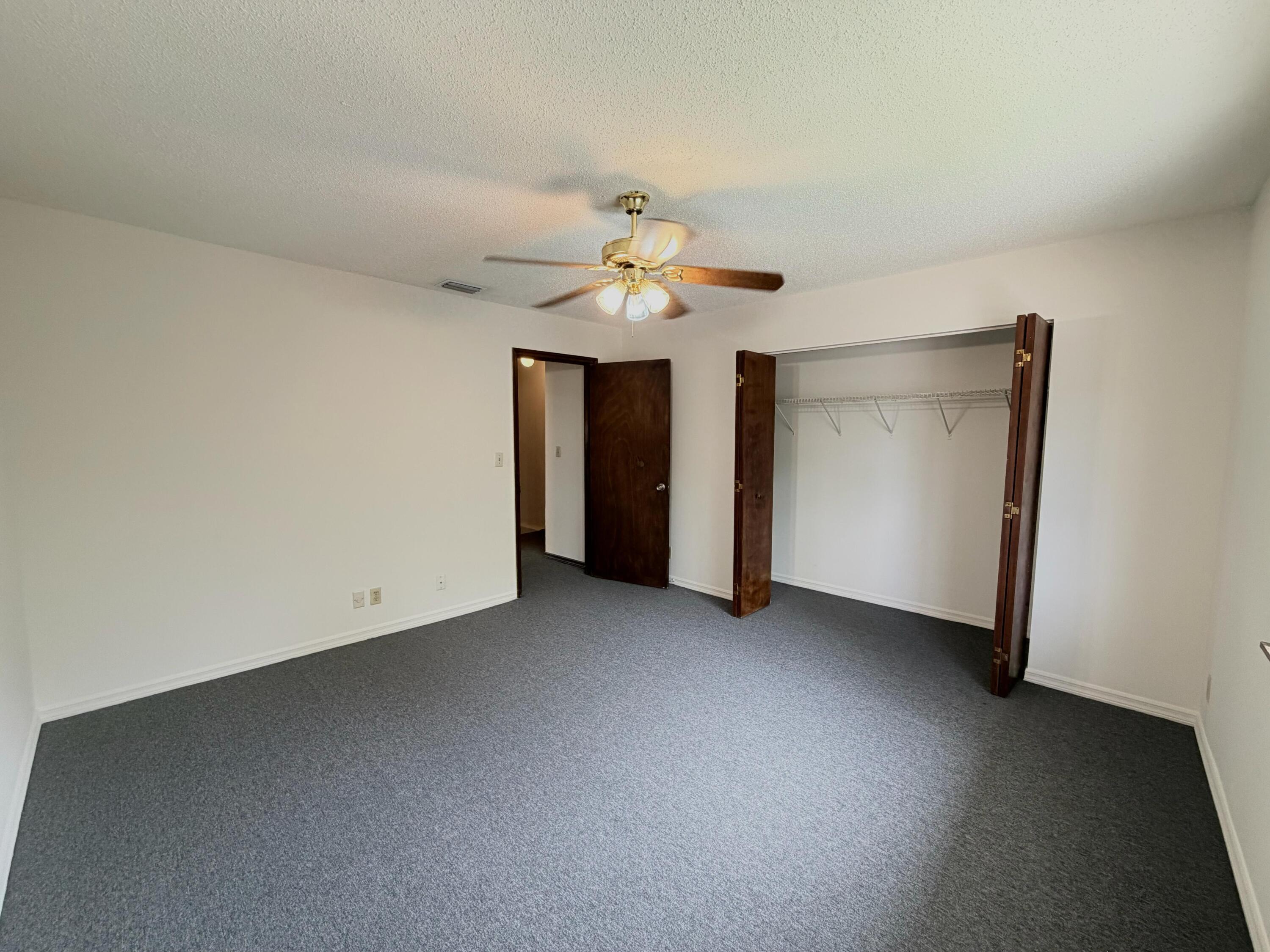 1226 Haverhill Road, Unit 3 Haverhill, FL 33417 - Photo 13 of 18 an empty room with a ceiling fan and a window
