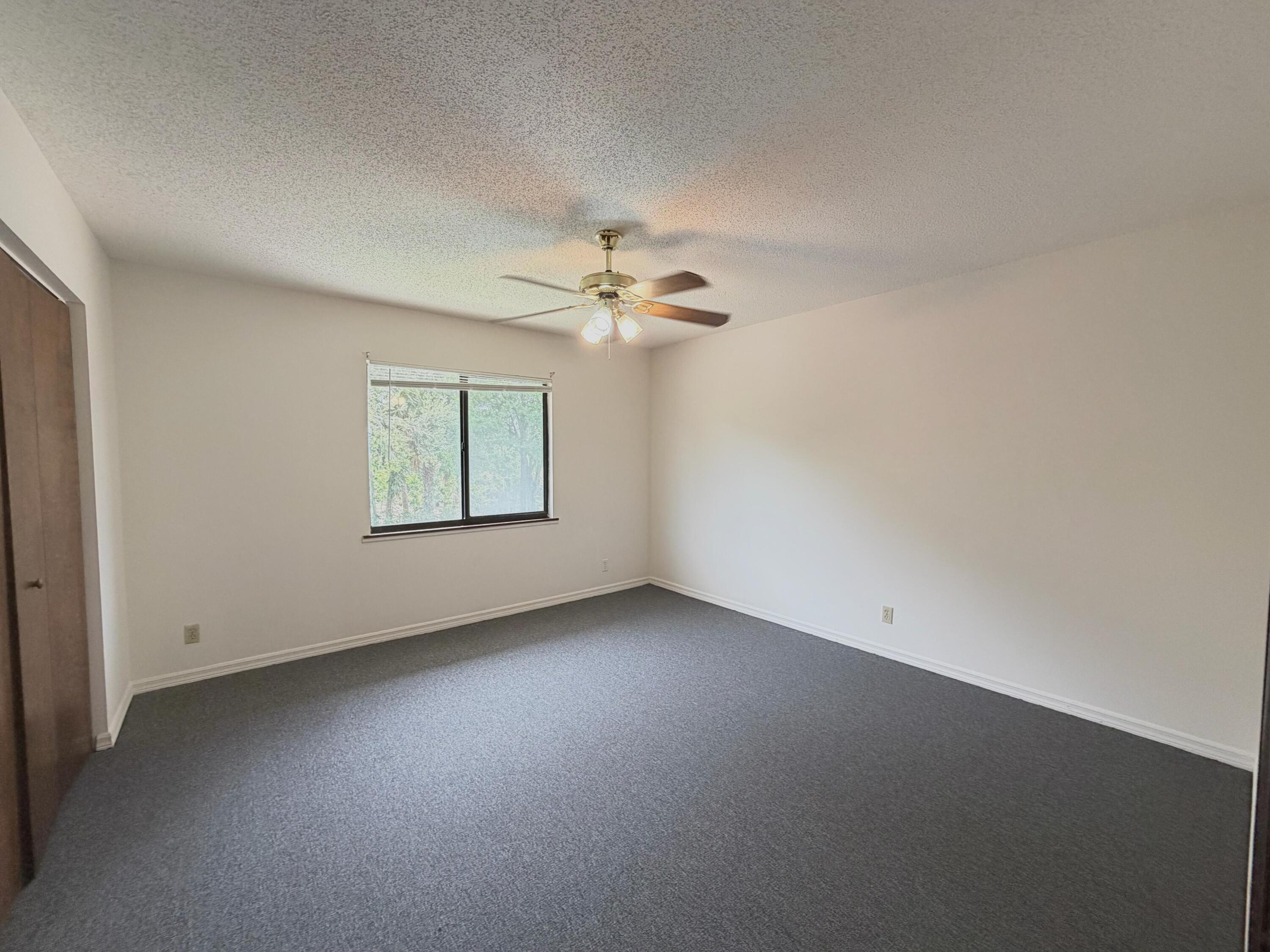 1226 Haverhill Road, Unit 3 Haverhill, FL 33417 - Photo 15 of 18 an empty room with a window