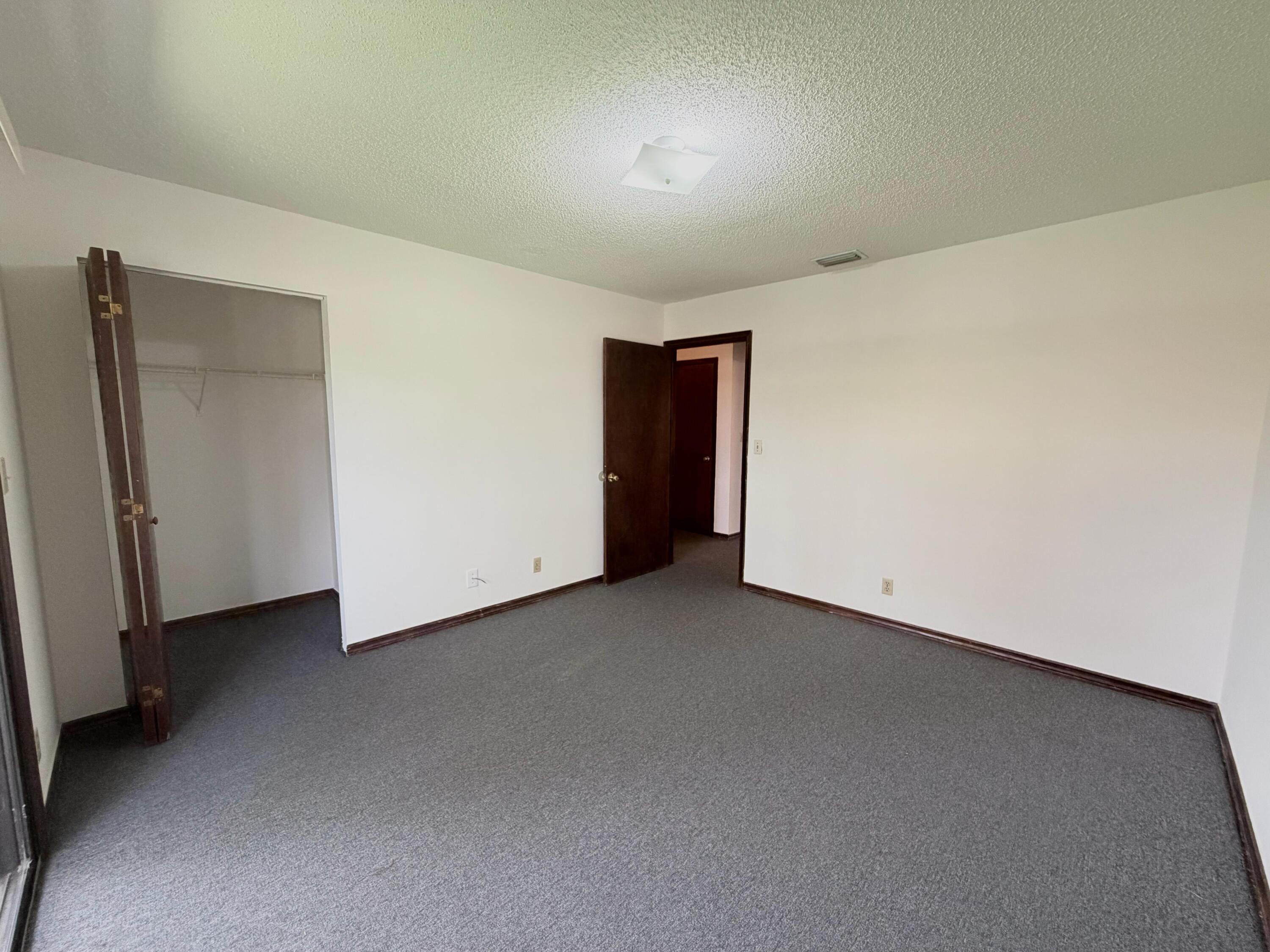 1226 Haverhill Road, Unit 3 Haverhill, FL 33417 - Photo 17 of 18 a view of an empty room and closet area