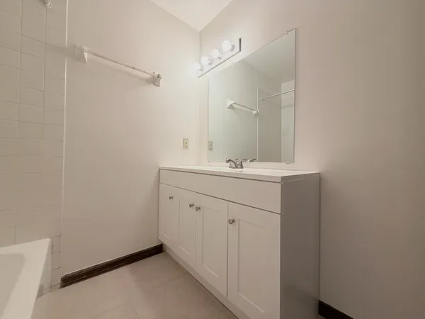 a bathroom with a sink vanity and a mirror
