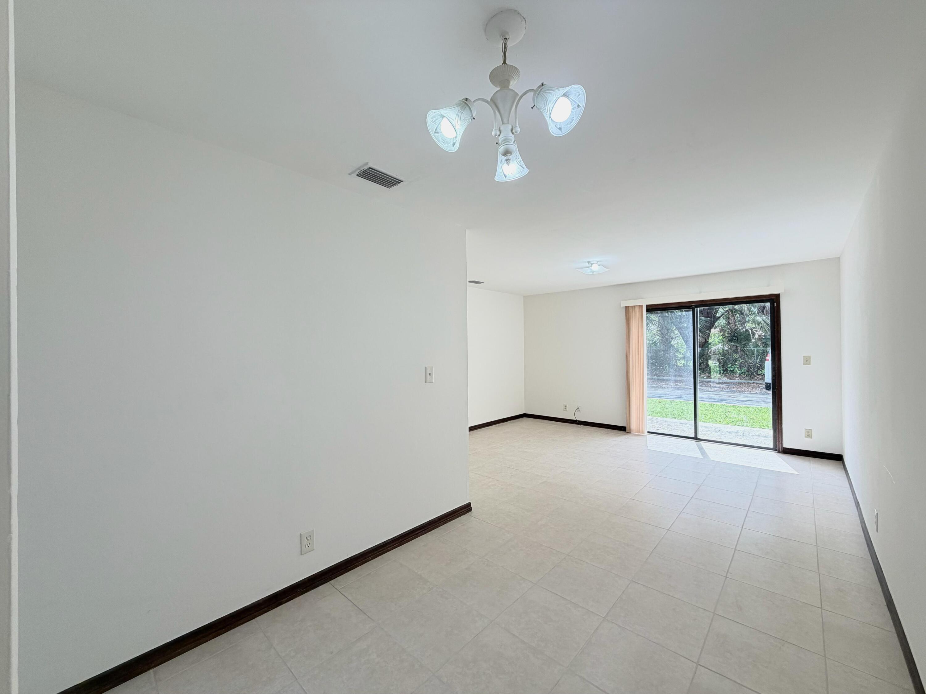 1226 Haverhill Road, Unit 3 Haverhill, FL 33417 - Photo 7 of 18 a view of an empty room with a window