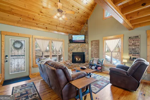 a living room with furniture a fireplace and a large window