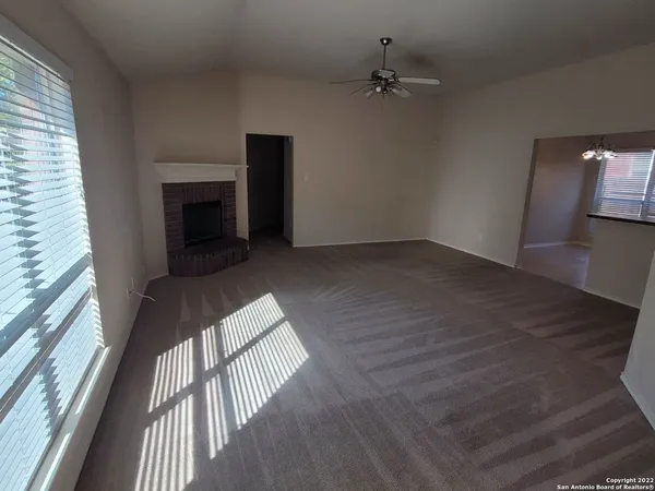 wooden floor in an empty room with a fireplace