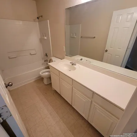 a spacious bathroom with a sink a toilet and shower