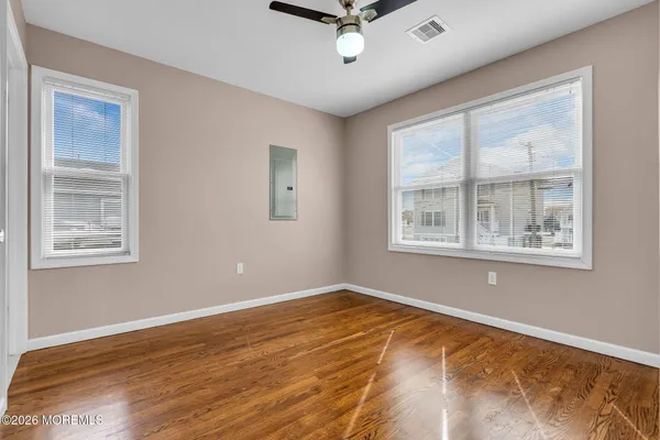 a view of a livingroom with a ceiling fan and window