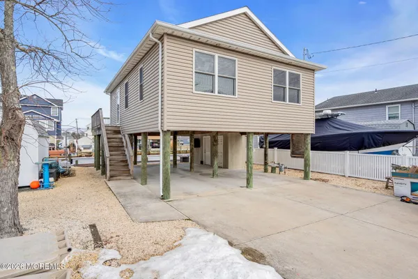 a view of a house with a patio and a yard