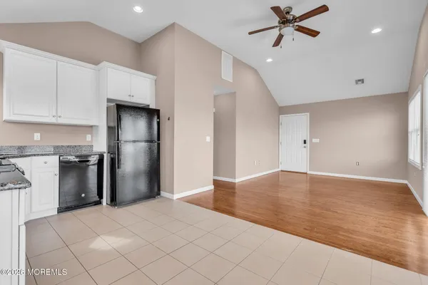 a view of a kitchen with a sink and refrigerator