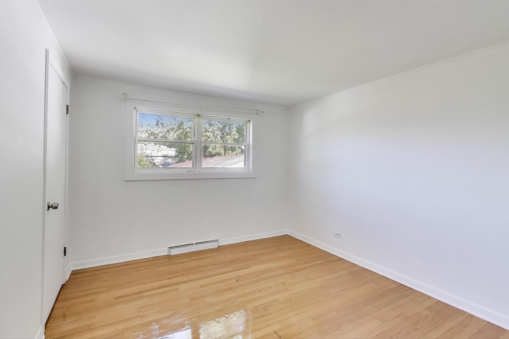 7332 Davis Street Morton Grove, IL 60053 - Photo 11 of 30 a view of empty room with wooden floor and fan