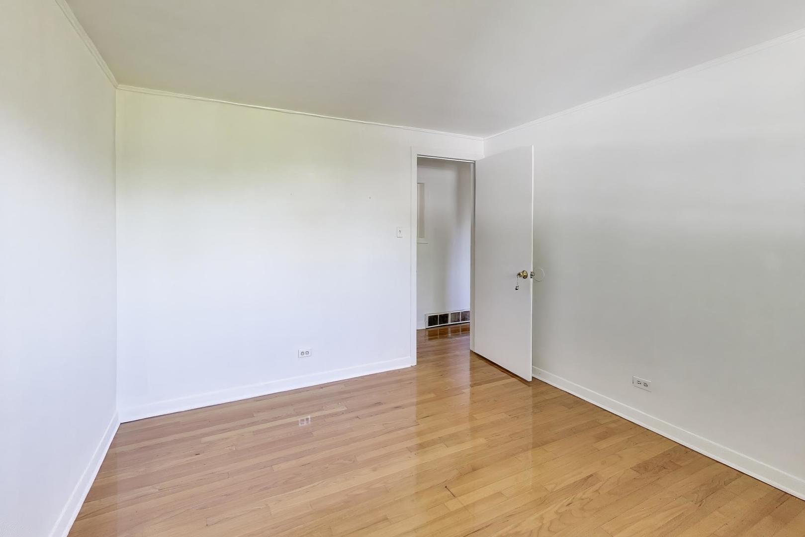 7332 Davis Street Morton Grove, IL 60053 - Photo 12 of 30 an empty room with wooden floor