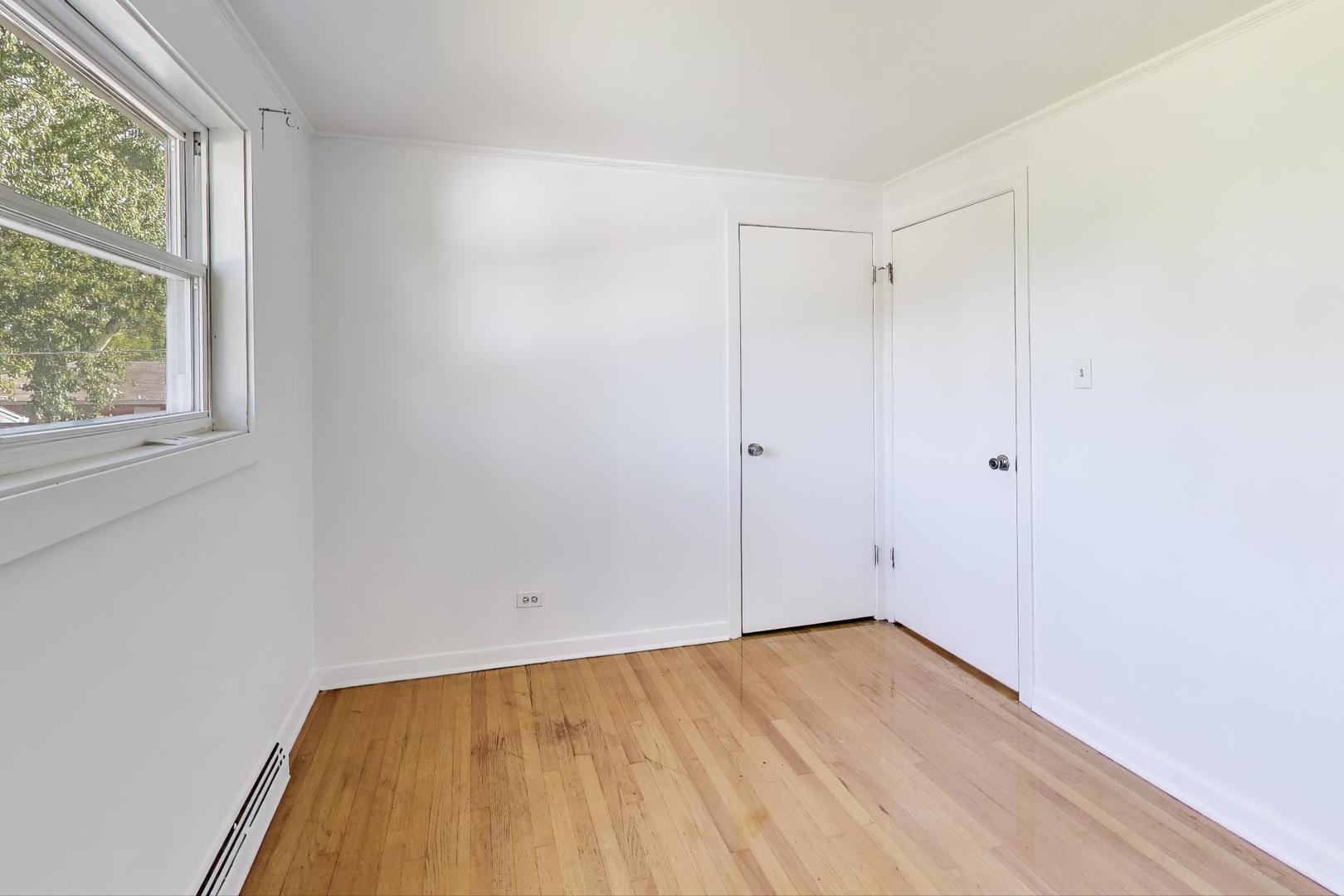 7332 Davis Street Morton Grove, IL 60053 - Photo 14 of 30 a view of empty room with wooden floor and fan