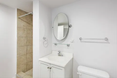 a bathroom with a sink a toilet and a mirror