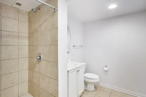 a bathroom with a toilet and a shower