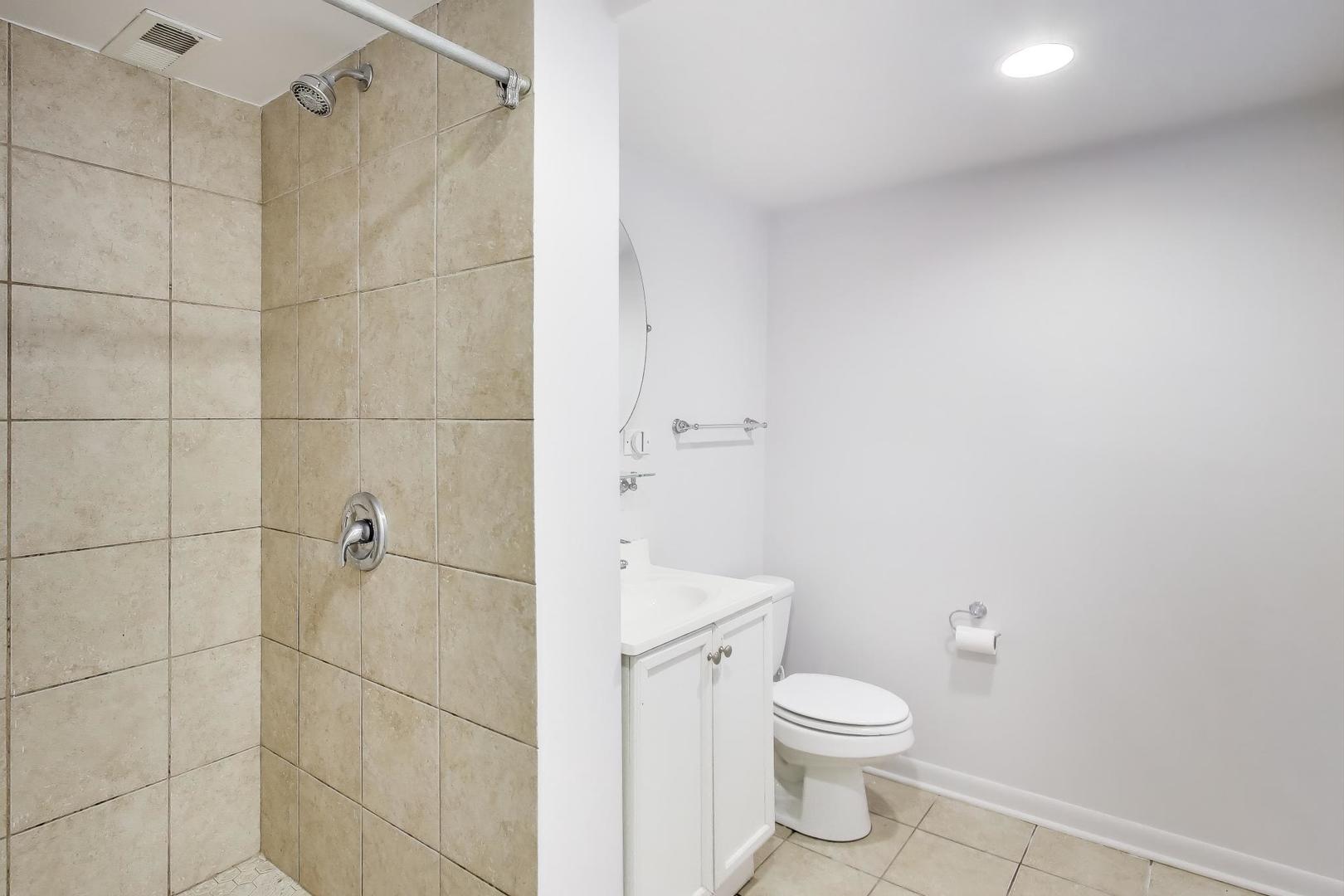 7332 Davis Street Morton Grove, IL 60053 - Photo 19 of 30 a bathroom with a toilet and a shower