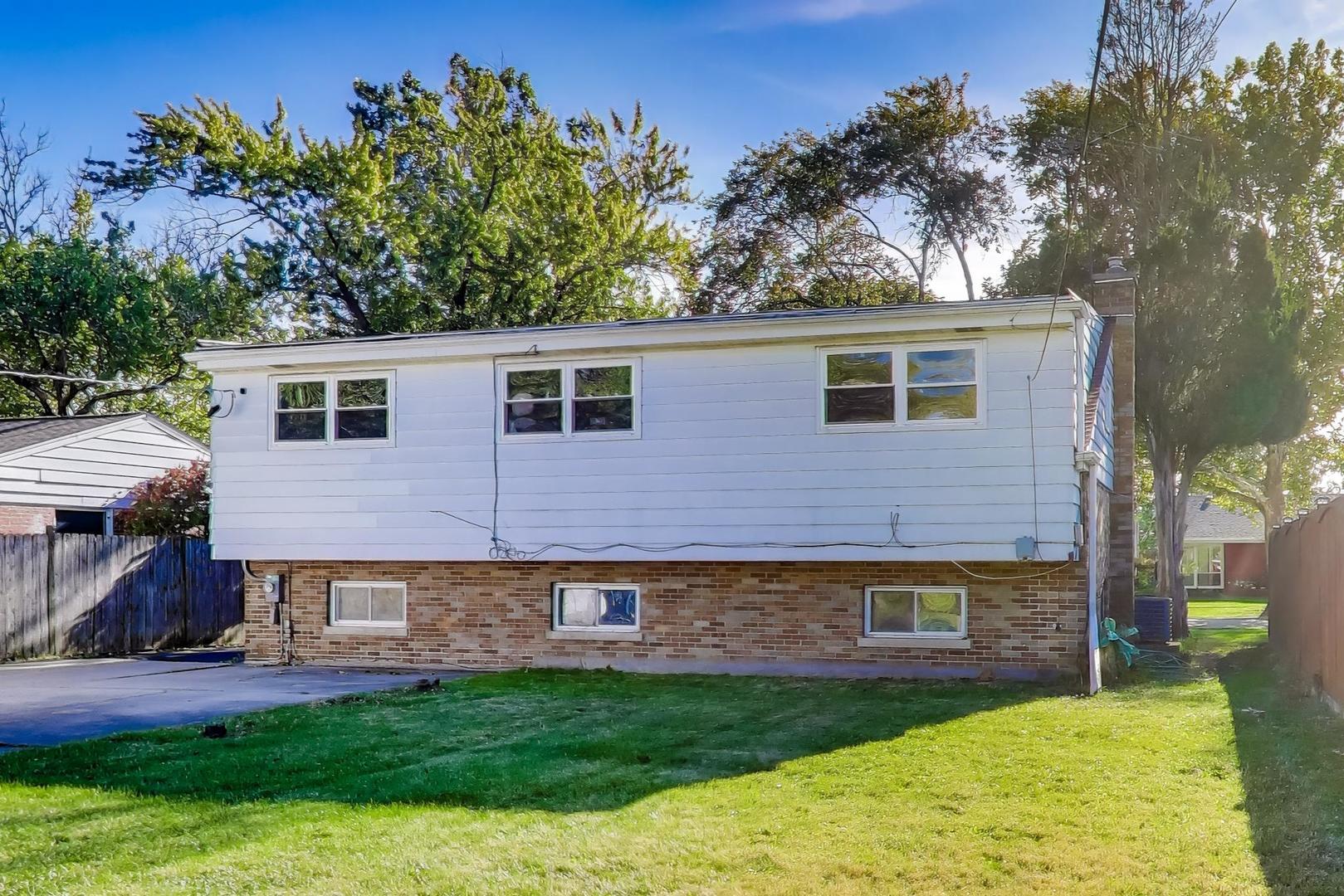 7332 Davis Street Morton Grove, IL 60053 - Photo 23 of 30 a front view of a house with a yard and garage