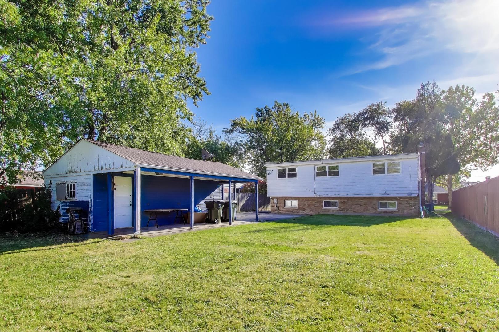 7332 Davis Street Morton Grove, IL 60053 - Photo 27 of 30 a front view of house with yard and entertaining space