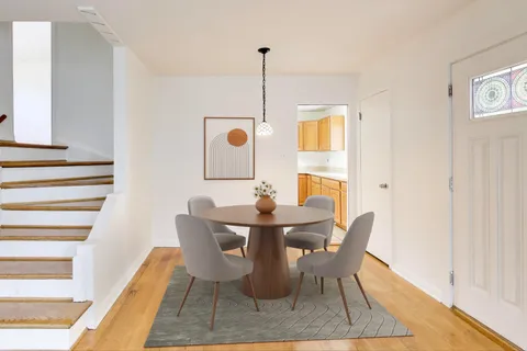 a dining room with furniture and window