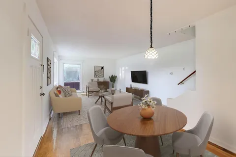 a living room with furniture a rug and a chandelier