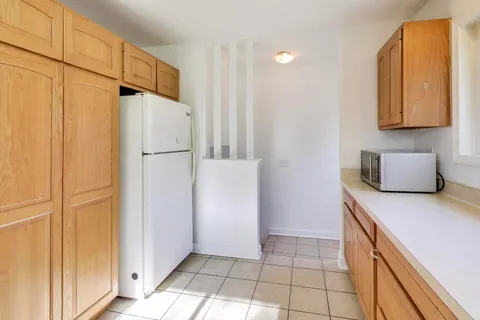 a kitchen with a refrigerator and cabinets