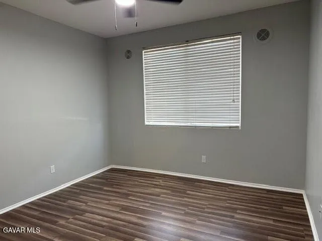 a view of a room with wooden floor and a window