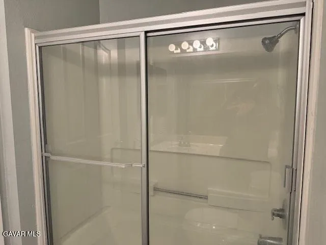 a bathroom with a glass shower door