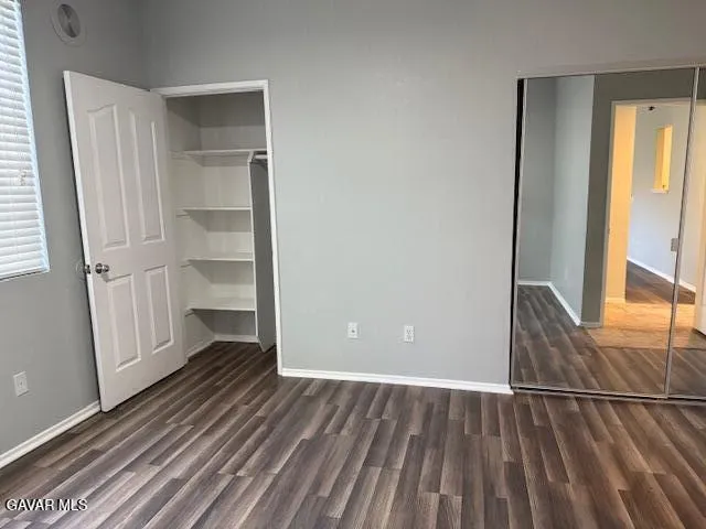 a view of a room with wooden floor and entryway