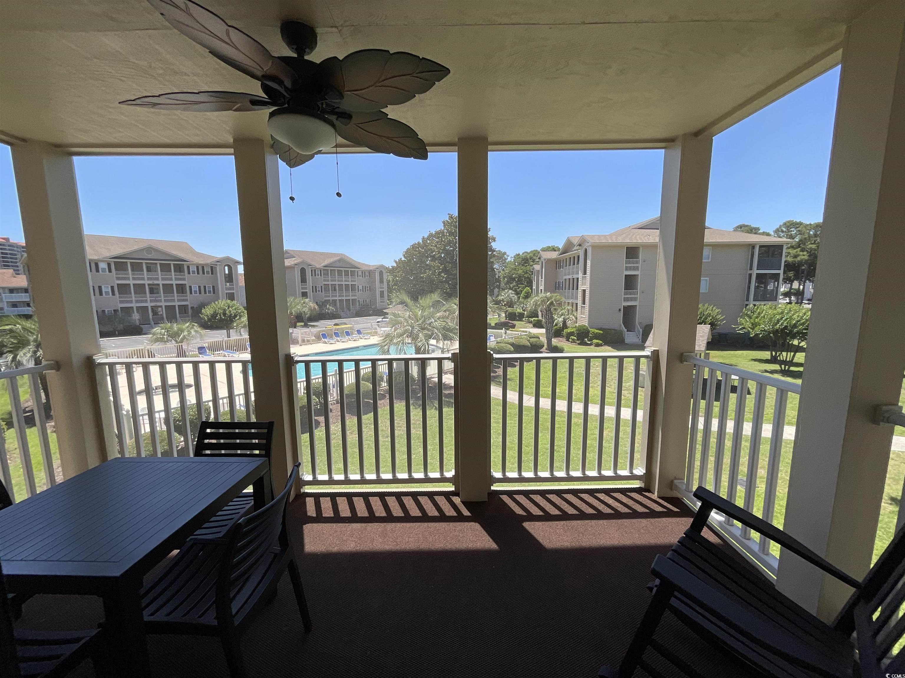 1900 Duffy Street, Unit L5 North Myrtle Beach, SC 29582 - Photo 13 of 18 Balcony with ceiling fan, a residential view, and view of pool