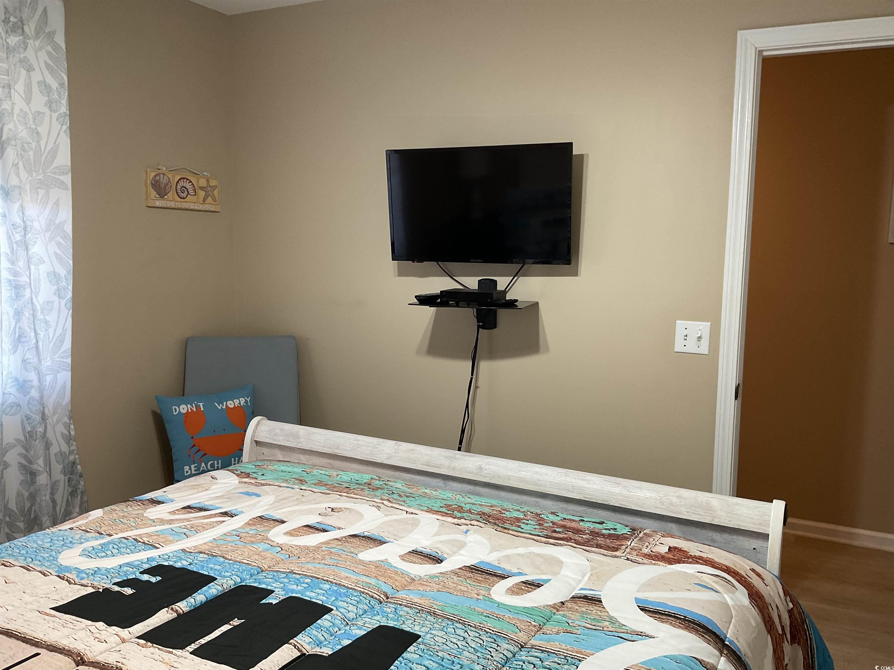 1900 Duffy Street, Unit L5 North Myrtle Beach, SC 29582 - Photo 4 of 18 Bedroom with wood finished floors and baseboards