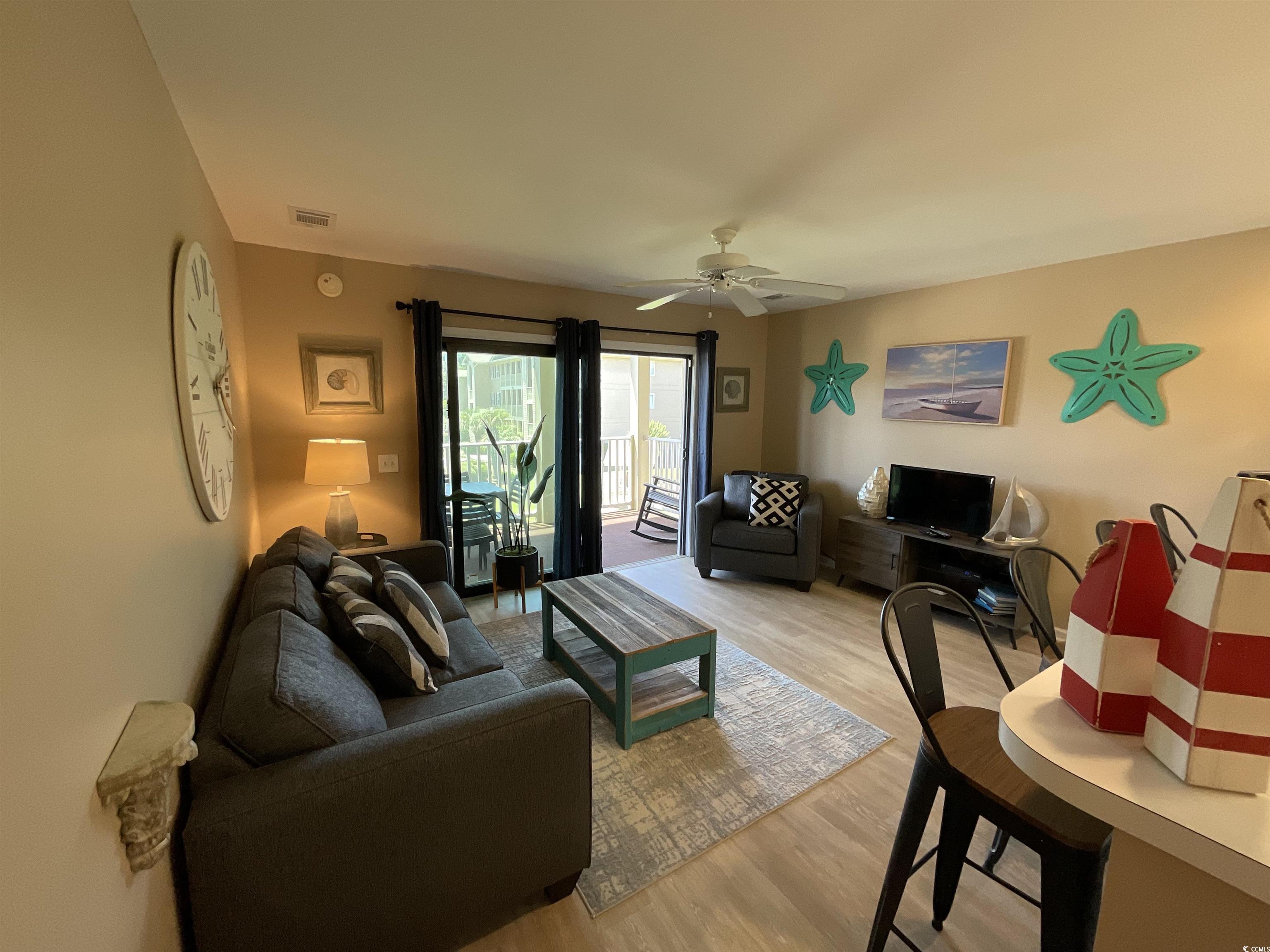 1900 Duffy Street, Unit L5 North Myrtle Beach, SC 29582 - Photo 7 of 18 Living area featuring light wood finished floors and ceiling fan