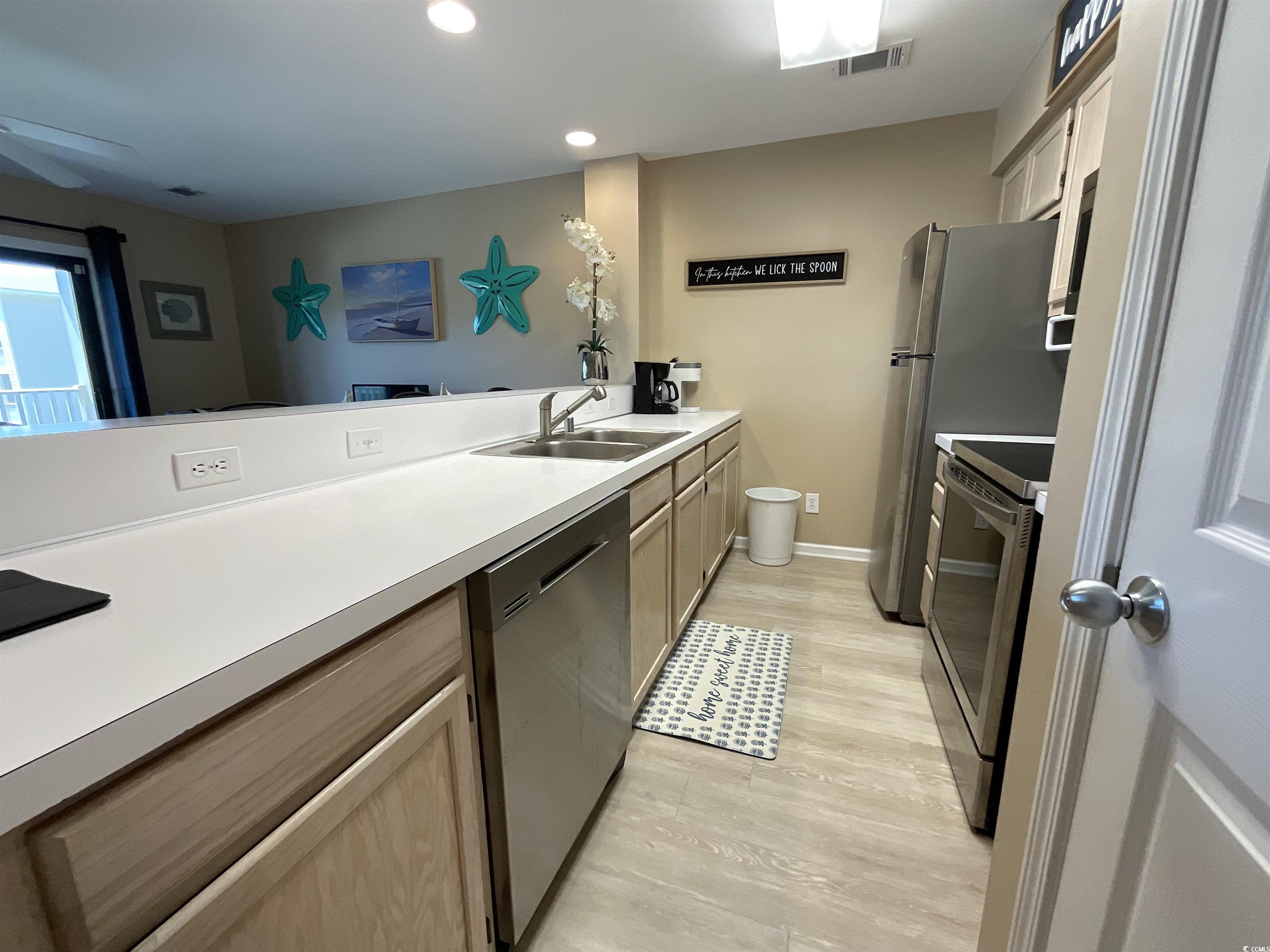 1900 Duffy Street, Unit L5 North Myrtle Beach, SC 29582 - Photo 9 of 18 Kitchen featuring stainless steel appliances, a sink, light countertops, ceiling fan, and recessed lighting