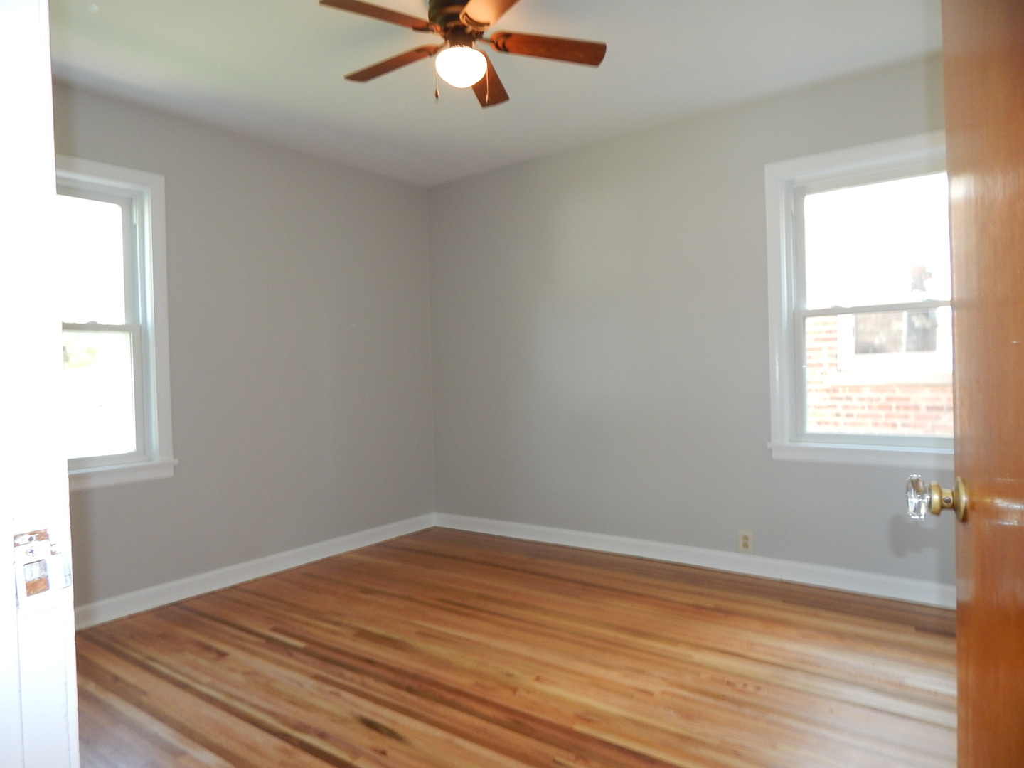 7611 East Prairie Road Skokie, IL 60076 - Photo 4 of 20 wooden floor in an empty room with a window