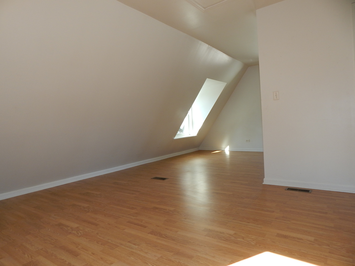 7611 East Prairie Road Skokie, IL 60076 - Photo 8 of 20 a view of a big room with wooden floor and windows